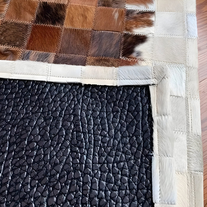 A sophisticated rectangular carpet featuring white and brown cowhide for your living space.