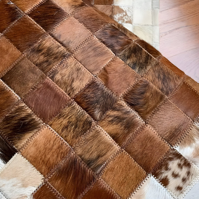 An exquisite rectangular carpet made from cowhide, perfect for a bedroom 