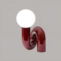 Sculptural wine red resin table lamp with white glass globe – artistic modern bedside light by MIRODEMI