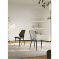 Pair of minimalist chairs in gray and dark green placed in a contemporary neutral room