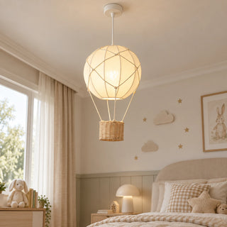 Aerella balloon pendant beside a bed in a soft neutral bedroom