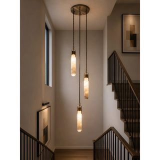 Modern three-light alabaster cluster pendant chandelier installed above a contemporary residential staircase.