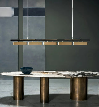 Albavilla minimalistic LED chandelier hanging above a designer marble table with abstract wall panels in the background