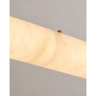 Detail of the Alvara pendant's natural alabaster tube veining lit from within with a brass fitting