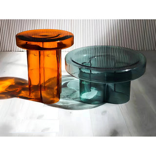 Amber and emerald sculptural glass accent tables with thick round tops