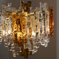 Murano chandelier detail featuring amber and clear textured glass elements with brass accents
