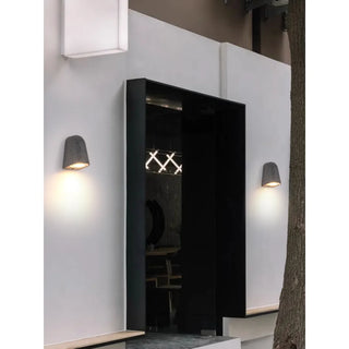 Pair of black sandstone wall sconces accenting a minimalist entryway