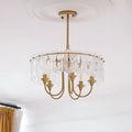 Modern Aurem bedroom glass chandelier in brass finish with clear textured glass elements