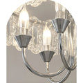 Close-up of illuminated bulbs and chrome arms on Aurem glass chandelier
