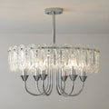 Illuminated Aurem chrome chandelier with textured glass panels and warm lighting