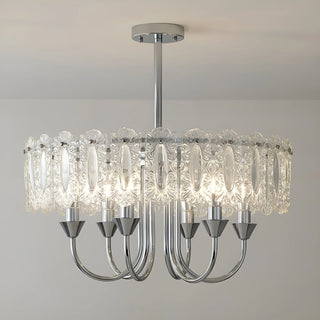 Illuminated Aurem chrome chandelier with textured glass panels and warm lighting
