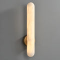Aurora alabaster wall sconce glowing with warm ambient LED lighting