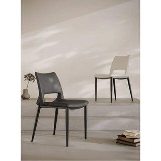 Staged shot of black and white dining chairs in light and shadow setting