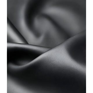 Close-up of smooth and soft black faux leather material with natural grain and gentle shine