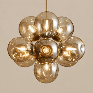 Bollara ten-light champagne glass cluster chandelier glowing against a warm neutral background