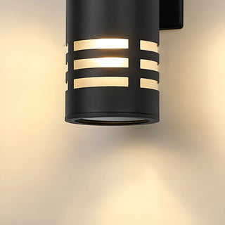 Bottom view of the dual-beam wall light glowing with warm light