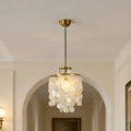 Brass canopy of a hanging chandelier on a light arched ceiling, showing ceiling mounting details
