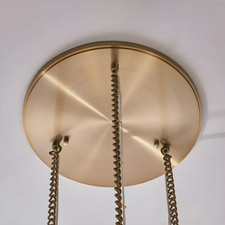 Brushed brass round ceiling canopy for a luxury alabaster cluster staircase chandelier with adjustable suspension chains.