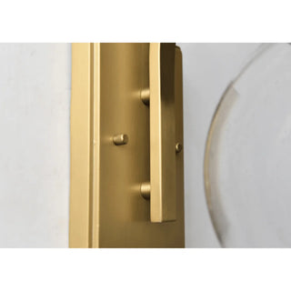 Luxury villa exterior with modern gold outdoor wall sconce lighting the entrance at night
