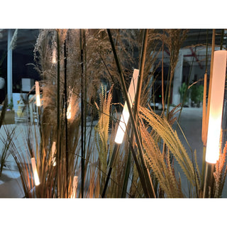 Bulrush-style LED lights seamlessly integrated among tall grass and plants