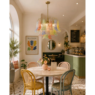 Calyra multicolor Murano glass chandelier installed in a stylish modern café interior with pastel decor