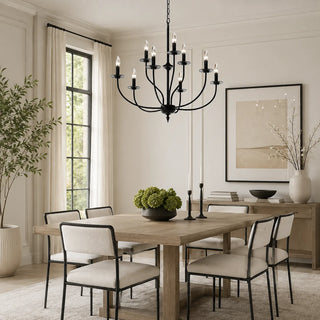 Black Candelara candle chandelier above a wooden dining table in a bright transitional dining room