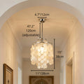 Capiz shell pendant chandelier in a hallway with dimensions: 47.2" adjustable drop, 15" height, 11" diameter, walls decorated with framed artwork