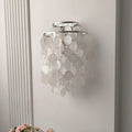 Side view of a chrome Capiz Shell Wall Sconce highlighting the layered shell disc arrangement and contemporary design