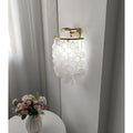Gold Capiz Shell Wall Sconce installed in a modern living room, providing decorative ambient lighting