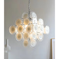 Cassia cream glass cluster chandelier in chrome finish illuminated in a modern space