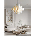 Cassia cream glass cluster chandelier in chrome finish hanging in a bright modern living room