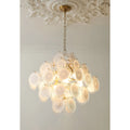 Angled view of the warm glowing Cassia cluster chandelier in copper finish