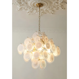 Angled view of the warm glowing Cassia cluster chandelier in copper finish