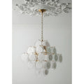 Cassia cream glass cluster chandelier in copper finish hanging from a decorative ceiling