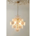 Front view of the illuminated Cassia cream glass cluster chandelier in copper