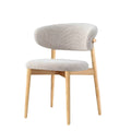Side view of white Casto chair with a soft rounded backrest and natural wood base