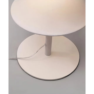 Close-up of the sleek white metal base of the Celeste modern floor lamp