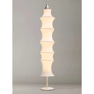 Glowing Celeste white silk modern floor lamp showing warm ambient lighting