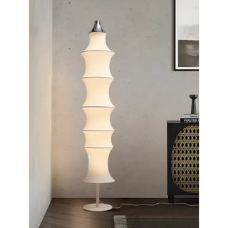 Celeste white silk modern floor lamp illuminated in a stylish contemporary living room
