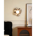 Close-up view of the Celestia Marble & Glass Wall Sconce featuring a flower white marble backplate.