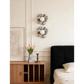 Pair of Celestia Marble & Glass Wall Sconces in flower white marble above a bedroom nightstand.
