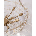 Detailed view of gold chandelier frame with multiple bulb arms and clear textured glass globes