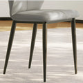 Close-up of the soft gray seat cushion and black legs of the chair, highlighting craftsmanship
