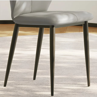 Close-up of the soft gray seat cushion and black legs of the chair, highlighting craftsmanship