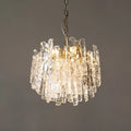Illuminated Murano glass chandelier with clear textured glass and warm ambient lighting.
