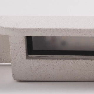 Close-up of the textured surface and hidden LED compartment of the white wall light