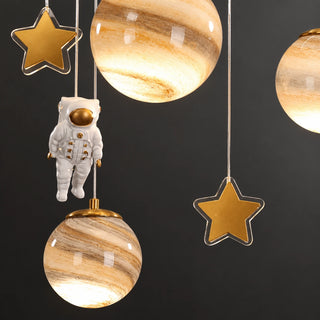 Close-up of Astrielle illuminated planets, gold stars and astronaut decoration