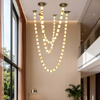 Collier Cloudstone Chain Chandelier illuminating staircase – modern LED copper & cloudstone design by Mirodemi