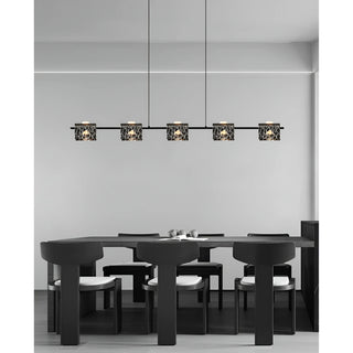 Copper linear chandelier with textured glass shades hanging above a contemporary kitchen island