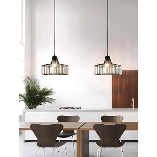 Pair of black K9 crystal pendant lights hanging above a wooden kitchen dining table